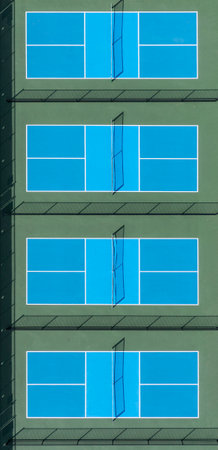 Overhead view of a new pickleball facility with blue and green courts in a suburban park in early spring.の写真素材