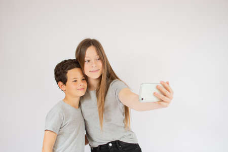 Two friends taking a picture with their phone