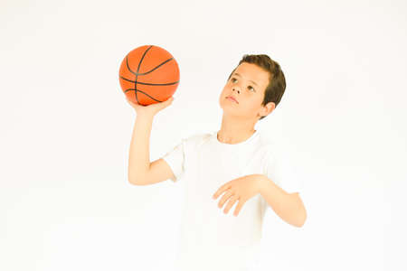Boy in white shirt smiling with a ballの写真素材