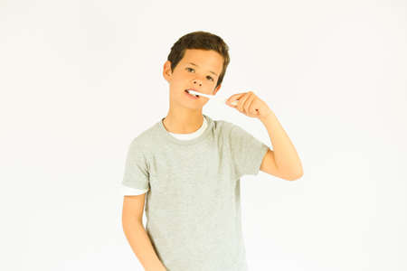 Young beautiful boy is brushing teeth