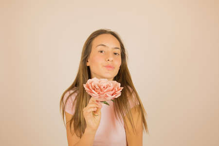 Beautiful girl with rose in her hand