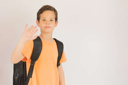 Boy is going to school looking into camera