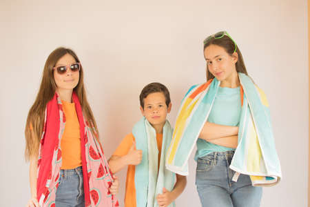 Beautiful girls and boy with towel ready for summer