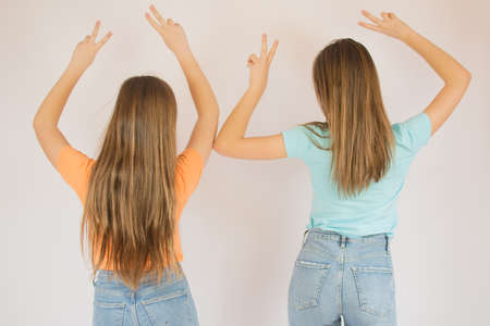 Girls making a victory gesture for the camera