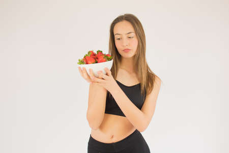 beautiful fitness girl with strawberriesの写真素材