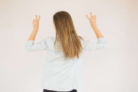 Beautiful young girl making a victory poseの写真素材