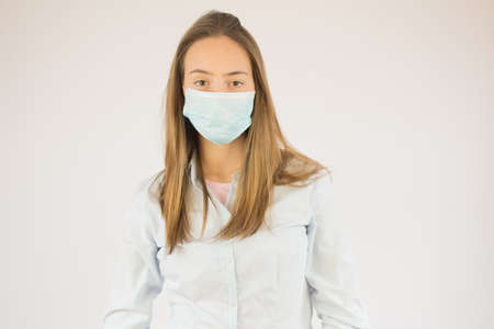 Beautiful young girl with maskの写真素材