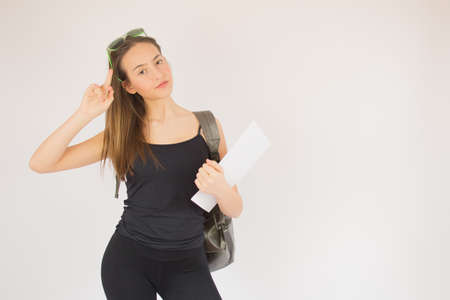 Young beautiful schoolgirl with glasses and bag