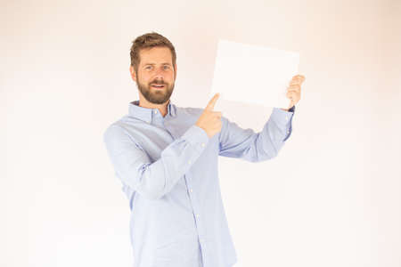handsome young man in blue shirt with paper