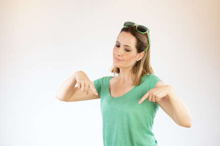 Young beautiful woman showing something with her handsの写真素材