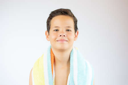 Portrait of a smiling handsome boy with beach towel