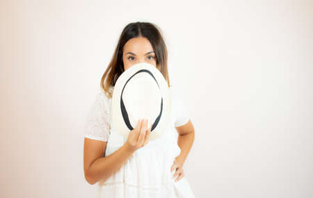 Beautiful young woman in white dress smilingの写真素材