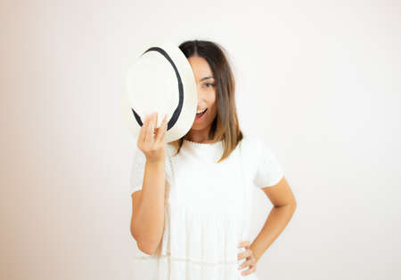 Beautiful young woman in white dress smilingの写真素材