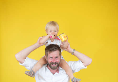 Father with his son on his arms smilingの写真素材