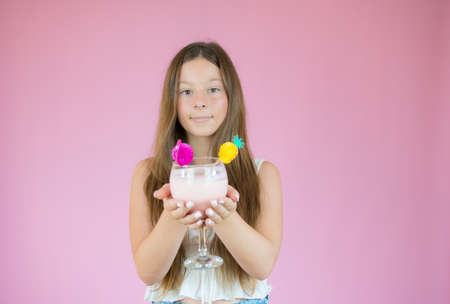Beautiful girl with long hair showing a smoothieの写真素材