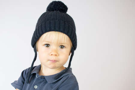 Smiling blond baby with a winter hat