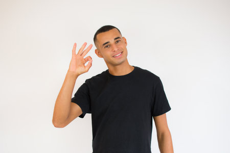 Handsome latin american young man wearing casual clothes doing stop sign with palm of the handの写真素材