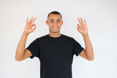 Handsome latin american young man wearing casual clothes doing stop sign with palm of the hand