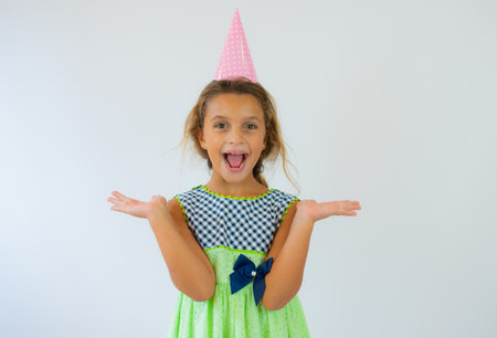 Funny little girl with hands painted in colorful paint. Isolated on white background.の写真素材