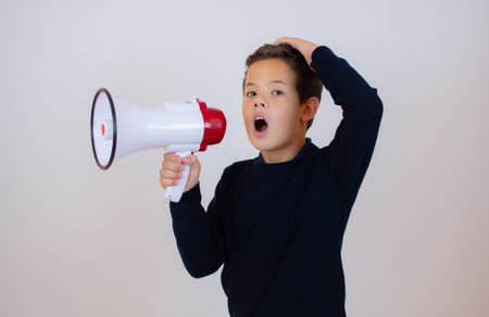 Confident cool boy with dark blue sweater and sunglasses, isolated on white backgroundの写真素材