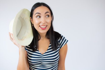 Portrait of a happy young woman holding paper heart isolated over red backgroundの写真素材
