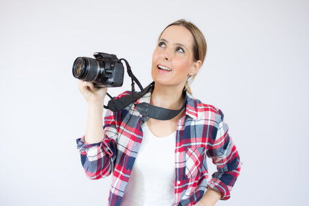 Young woman over isolated yellow background listening to something by putting hand on the earの写真素材