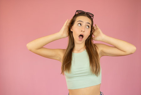 Shocked excited Beautiful caucasian woman with mouth open isolated on colorful pink backgroundの写真素材