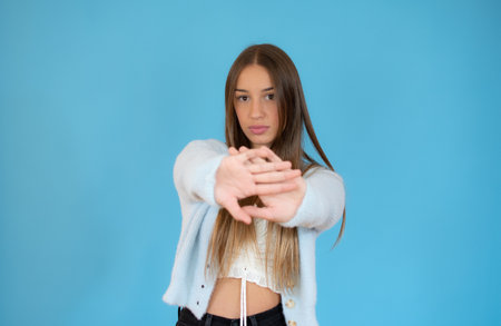 teen girl making photo frame gesture over blue backgroundの写真素材