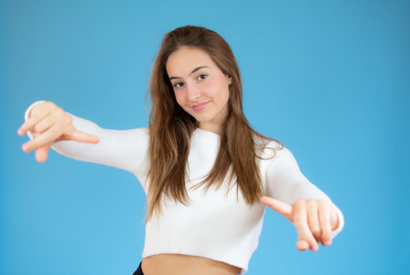 Portrait of surprised girl with mouth open standing isolated on a blue backgroundの写真素材