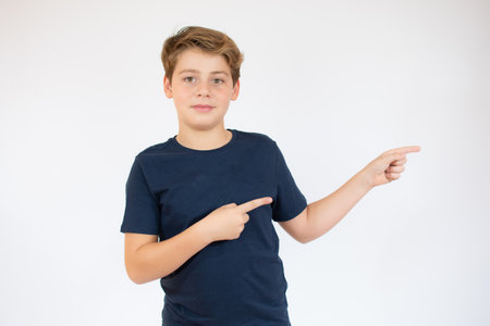 Boy in orange t-shirt preparing to dive over white background.の写真素材