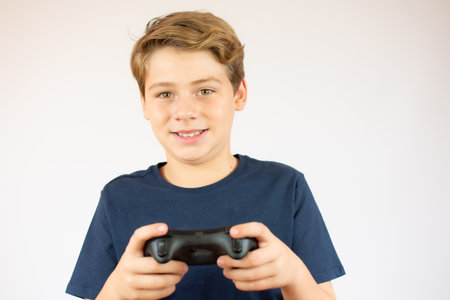 Boy in orange t-shirt preparing to dive over white background.の写真素材