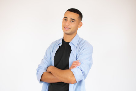 Portrait of happy handsome man in blue shirt crossing hands and look at camera