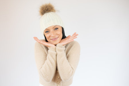 Close up of a smiling young woman in casual sweater isolated over white backgroundの写真素材