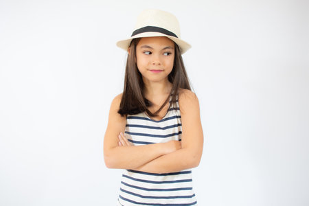Enjoying vacation. Good vibes. Beach style. Little beauty in straw hat. Portrait of happy cheerful girl in summer hat over white background.の写真素材