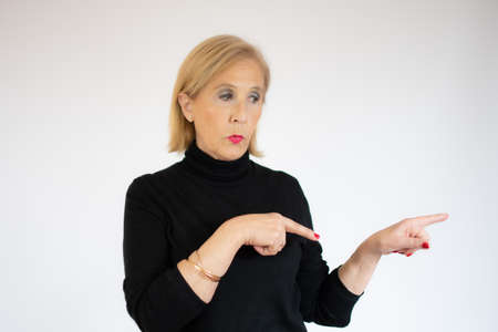 Beautiful middle age woman wearing winter sweater over isolated background presenting with hand and...
