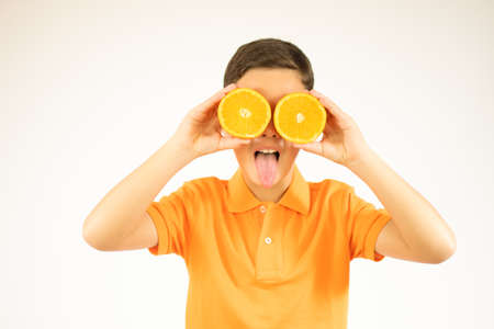 Funny boy with fruits on eyes, isolated on whiteの写真素材