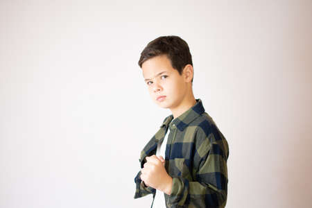 Portrait of a beautiful caucasian young boy smiling making a happy gesture over white backgroundの写真素材