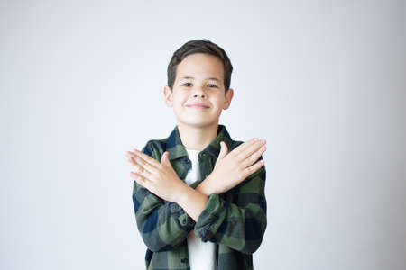 Little boy caucasian smiling kid wearing casual clothes rejection expression crossing arms and palmsの写真素材