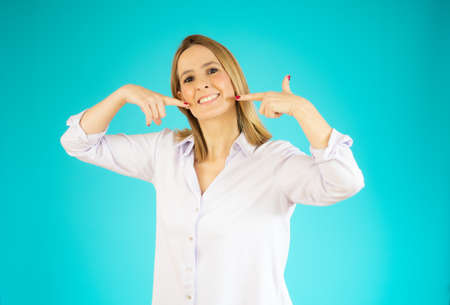 Young beautiful woman standing over purple isolated background smiling cheerful showing and pointing...