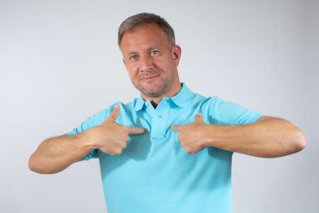 Young man proud of himself over white background.