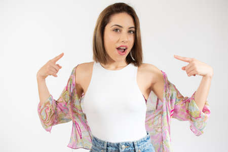 Young charming woman in casual clothes pointing at herself with smile over white backgroundの写真素材