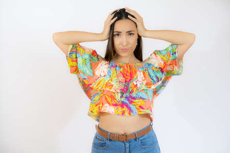 Portrait of a pensive beautiful young woman wearing casual clothes standing isolated over white backgroundの写真素材