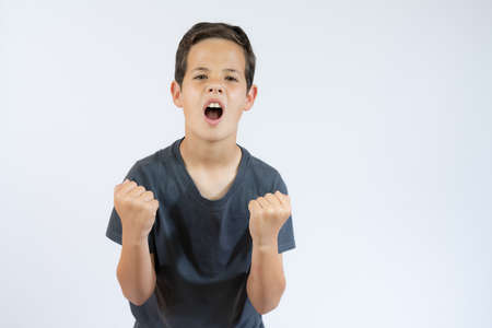 Let's hug. Portrait of friendly hospitable little boy in black T-shirt smiling happily and holding...