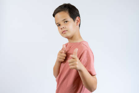 Let's hug. Portrait of friendly hospitable little boy in black T-shirt smiling happily and holding...