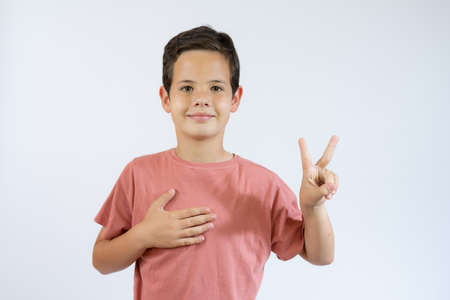 Let's hug. Portrait of friendly hospitable little boy in black T-shirt smiling happily and holding...