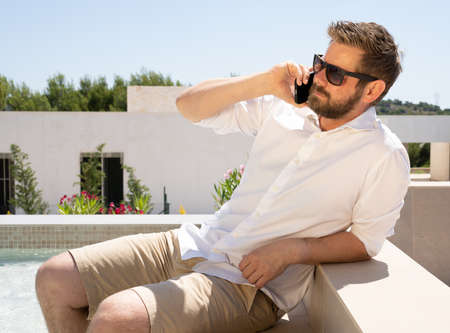 Young businessman working while on vacationの写真素材