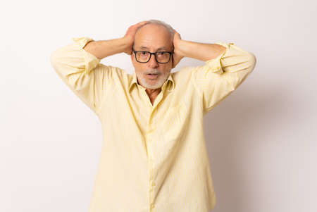 Photo of impressed old man scream isolated over white backgroundの写真素材