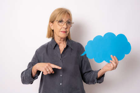 Happy senior woman holding blank sign isolated over white background.