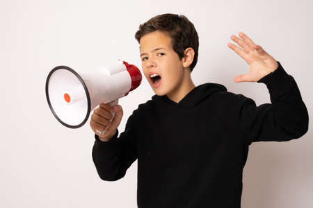 Cute little boy with megaphone on white backgroundの写真素材