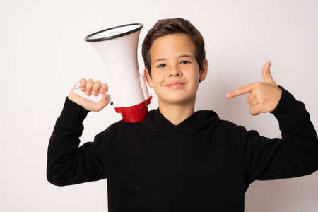 Cute little boy holding megaphone isolated over white backgroundの写真素材